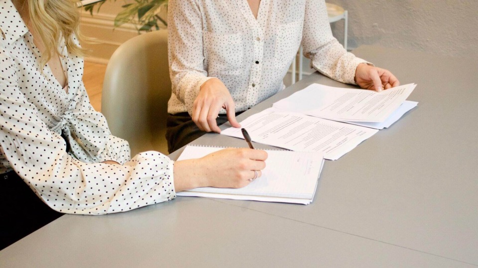 people signing documents