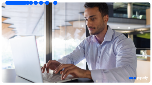 A professional works at a laptop in a modern office, managing the procure-to-pay process from request to payment