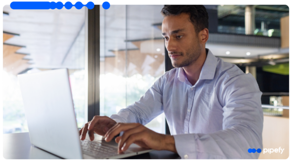 A professional works at a laptop in a modern office, managing the procure-to-pay process from request to payment