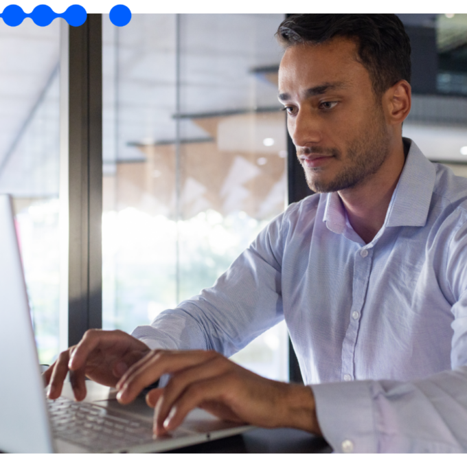 A professional works at a laptop in a modern office, managing the procure-to-pay process from request to payment