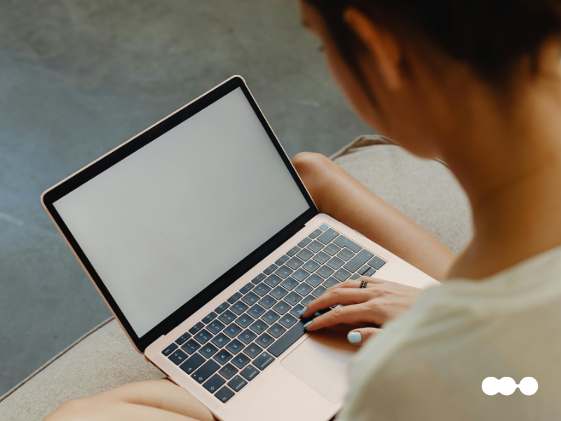 Close-up of a professional accessing an employee portal on a blank laptop screen, symbolizing the start of a digital journey