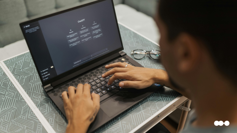Employee using AI tool on a laptop for internal feedback and coaching tasks