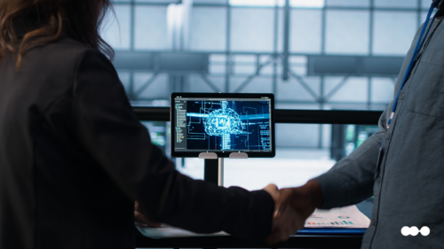 Profissionais cumprimentando-se em frente a tela com imagem de cérebro digital, simbolizando a atuação de agentes de IA no jurídico com segurança e automação