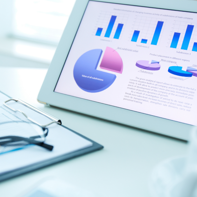 Tablet displaying charts and graphs used to compare financial reports across business units