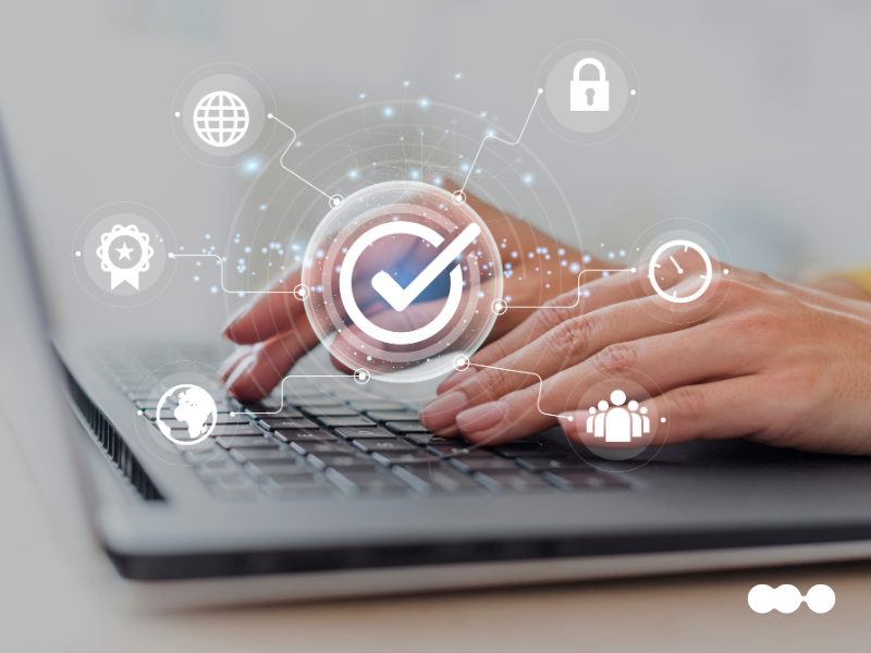 Digital interface with icons for security, time, and approval over hands typing on a notebook
