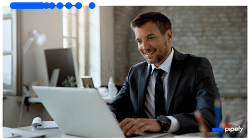 Business professional using a laptop in office environment, illustrating efficiency gains with digital forms in FNOL reporting