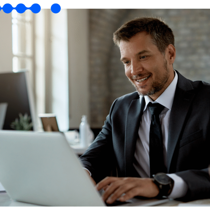 Business professional using a laptop in office environment, illustrating efficiency gains with digital forms in FNOL reporting