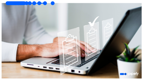 Person typing on a laptop with digital checklist icons, representing FNOL reporting automation in insurance workflows