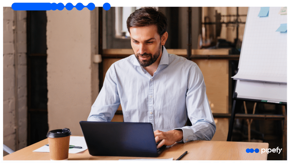 Business professional working on laptop representing RPA and task automation with Pipefy