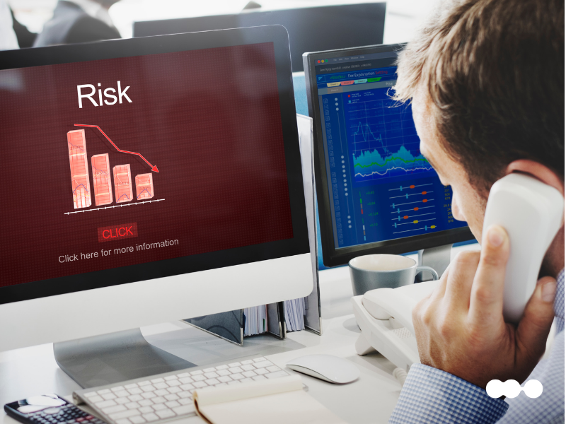 Professional analyzing financial dashboards for risk profiling