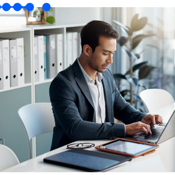 Business professional using laptop to manage risk profiling workflows in a modern office